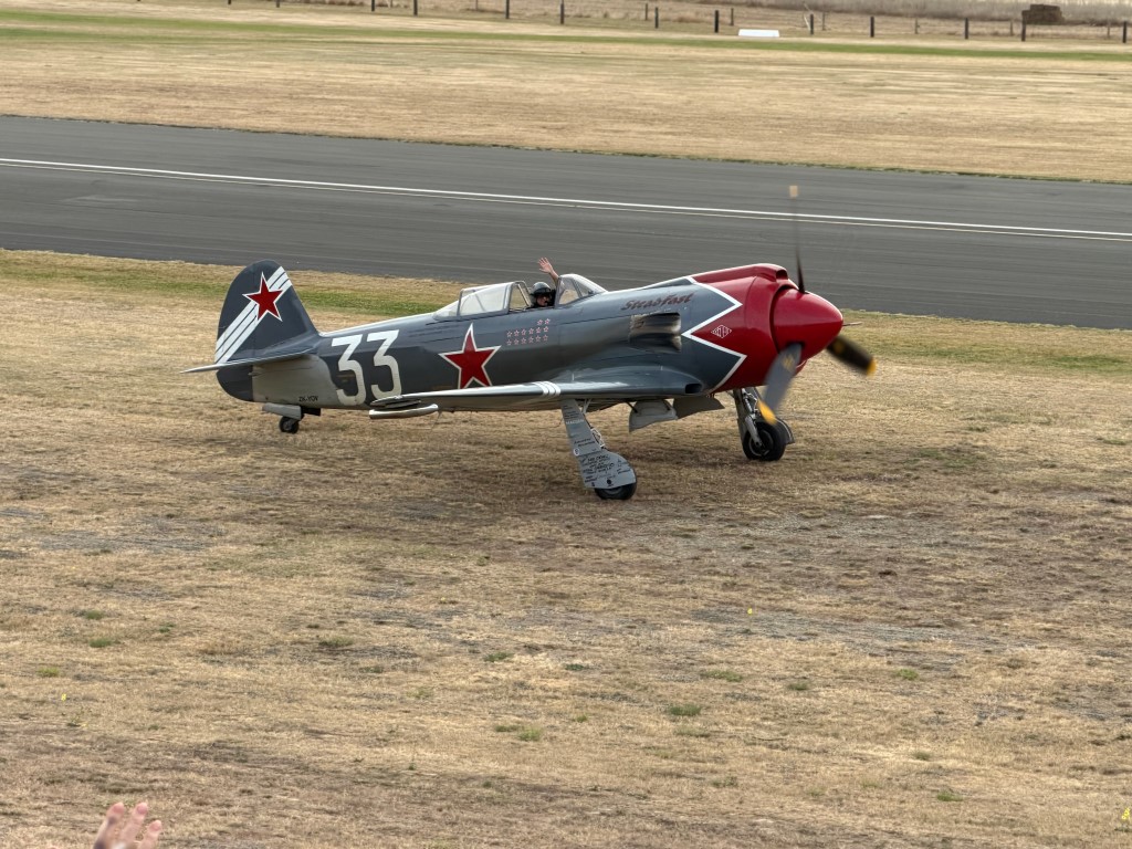 The spectacular Yakovlev Yak-3 SteadFast, ZK-VVS, taxying past the crowd at Warbirds Over Wanaka. The Yak-3 was one of the Soviet Union's finest fighters of WWII, renowned for its light weight, manoeuvrability and performance at lower altitudes. SteadFast is a later Russian-built example constructed using the original Yakovlev design and powered by an Allison V-1710 V12 engine. Finished as Soviet “White 33”, it certainly looks and sounds every bit the classic WWII fighter.
